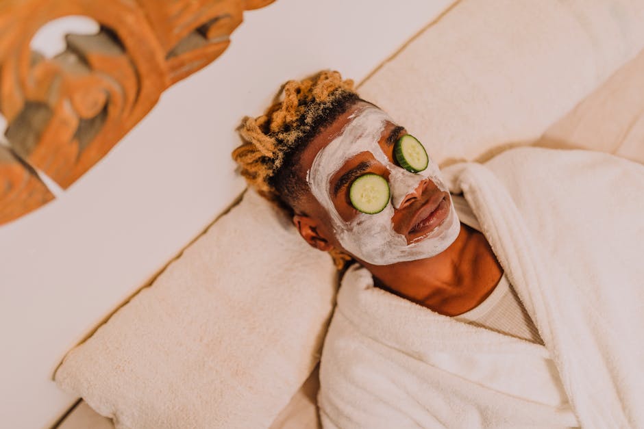 Person enjoying a relaxing spa treatment with cucumber facial mask for skincare.